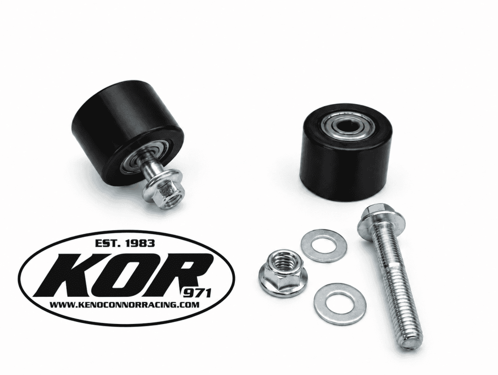 Two black Yamaha Blaster chain rollers with metal bearings, mounting bolts, nuts and washers on a white background.