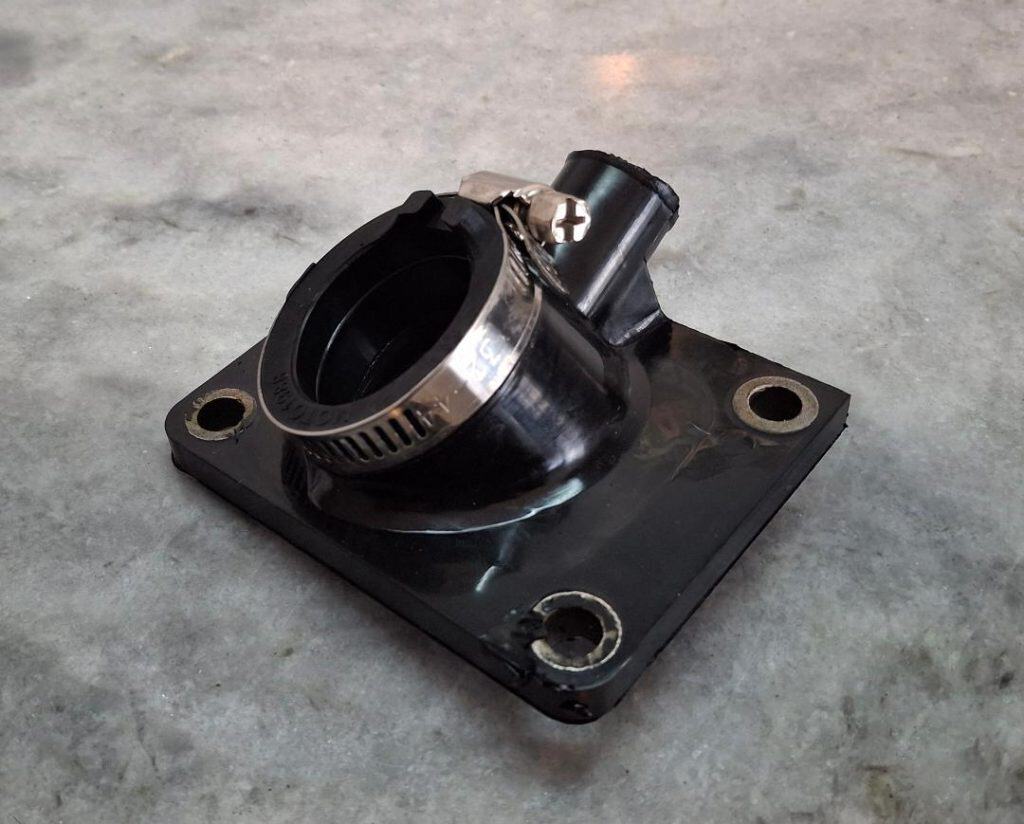 Racing car throttle body component for motorsport performance.